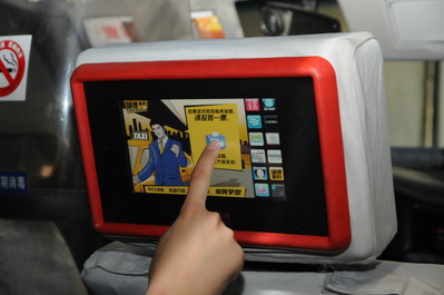 A passenger interacts with care for drivers campaign icon on touchmedia’s in-taxi touchscreen and votes for the driverdriving in the taxi. 